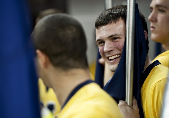 Michigan junior cheerleader Chris Fraga smiles while holding a flag before the game against Western Michigan on Tuesday. Daniel Brenner I AnnArbor.com